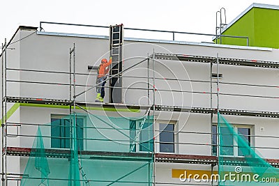 Demolition of scaffolding after thermal insulation and painting of the facade of an apartment house Editorial Stock Photo