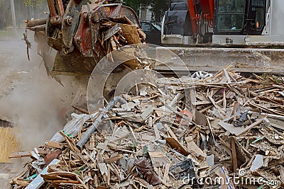 Demolition of wooden house in trash debris outside of neighborhoods devastated by hurricane Stock Photo