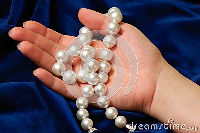 Demonstrating a pearls necklace Stock Photo