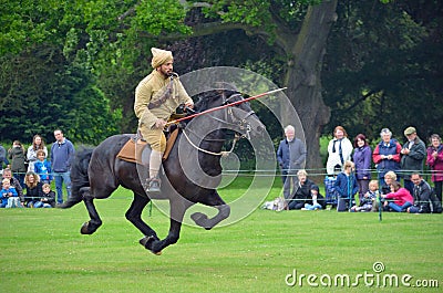 Demonstration of the sport of Tent Pegging at full gallop by a member of the Punjab Lancers in World War One uniform Editorial Stock Photo