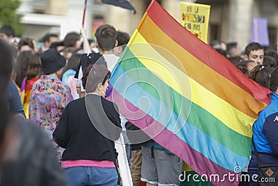 Demonstrator carrying the flag with the LGBT colors during the gay pride parade Editorial Stock Photo
