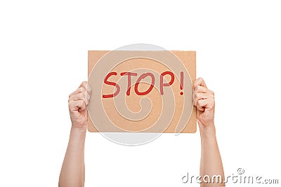 Demonstrator hands are holding protest poster with the message Stop. Stock Photo