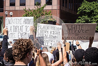 Demonstrators Hold Up Signs at a Protest of the Murder of George Floyd Editorial Stock Photo