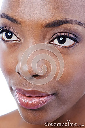 Demure Beauty. Closeup studio shot of a young beautiful african american model isolated on white. Stock Photo