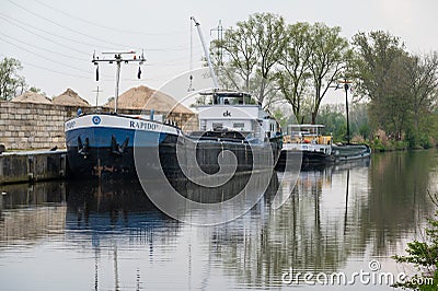 Dendermonde, East Flanders, Belgium - Industrial cargo ship Rapido at the banks of the River Dender Editorial Stock Photo