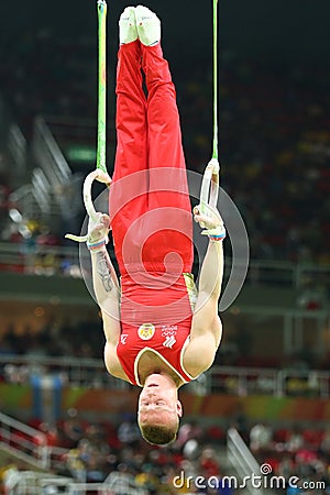 Denis Abliazin of Russian Federation competes at the Men`s Rings Final on artistic gymnastics competition at Rio 2016 Olympic Game Editorial Stock Photo