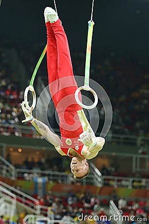 Denis Abliazin of Russian Federation competes at the Men`s Rings Final on artistic gymnastics competition at Rio 2016 Olympic Game Editorial Stock Photo