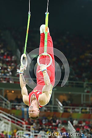 Denis Abliazin of Russian Federation competes at the Men`s Rings Final on artistic gymnastics competition at Rio 2016 Olympic Game Editorial Stock Photo