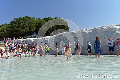 Denizli, Turkey. - July 20.2019. Tourists walk on a snow-white terraces at Pamukkale Editorial Stock Photo