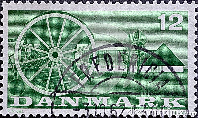 DENMARK - CIRCA 1960: A postage stamp from Denmark showing an seed drill in front of a farmhouse in Denmark Editorial Stock Photo