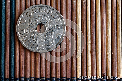 Denmark coin denomination is 5 krone (crown) lie on wooden bamboo table, good for background or postcard Stock Photo