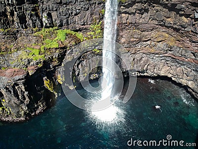 Denmark, Faroe Islands, Vagar Island, Gasadalur, village and waterfall falling into the sea Stock Photo