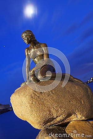 Denmark: Little Mermaid with moon and Jupiter Editorial Stock Photo