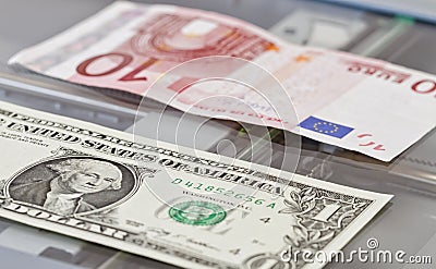 Denominations of one dollar and ten euros lie on scaner Stock Photo