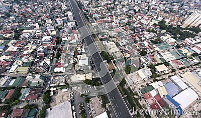 A dense and crowded section of Metro Manila separated by the Skyway, an elevated highway in the metropolis Stock Photo