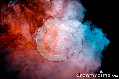 A dense, swirling cloud of colorful smoke against a black background, highlighted in red and blue in waves from the vape Stock Photo