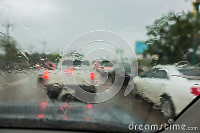 Dense traffic on a rainy day with raindrops on car glasses Stock Photo