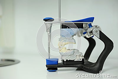 dental articulator with dental gypsum prosthesis model in dental laboratory An articulator used in dental laboratories Stock Photo