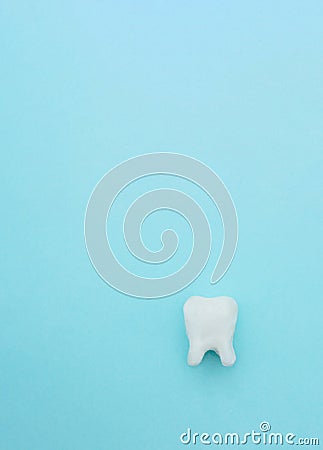 Dental care concept, white tooth model on blue background with copy space Stock Photo