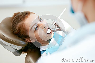 Dental Care. Girl During Dental Treatment In Dentistry Clinic Stock Photo