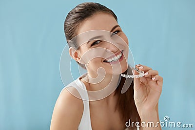 Dental care. Smiling woman using removable clear teeth braces Stock Photo