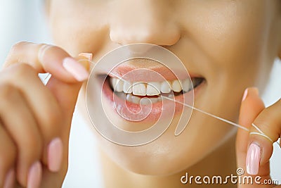 Dental Care. Woman With Beautiful Smile Using Floss For Teeth. H Stock Photo