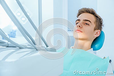 Dental caries prevention.Teenage boy at the dentist`s chair during a dental procedure, smile close up. Healthy Smile. Stock Photo