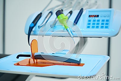 Dental chair with oral irrigator near doctor's unit with burs Stock Photo