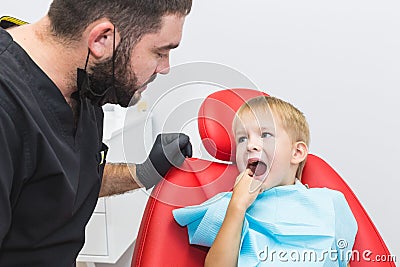 Dental clinic. Reception, examination of the patient. Teeth care. Dentist treating teeth of little boy in dentist office Stock Photo
