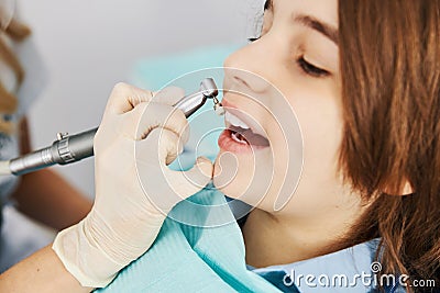 Dental drill with prophy brush treating boy teeth Stock Photo