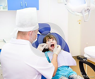 Dental examining being given to little girl by den Stock Photo