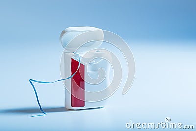 Dental floss on an blue background Stock Photo