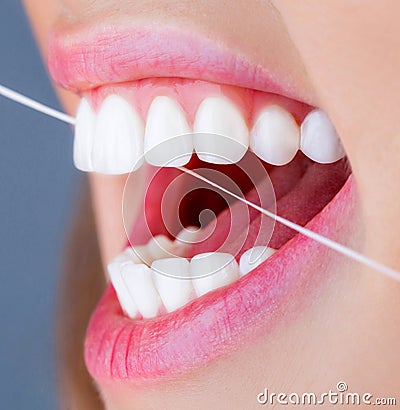 Dental floss. Oral hygiene and health care. Smiling women use dental floss white healthy teeth. Dental flush - woman Stock Photo