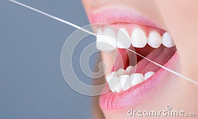 Dental flush - woman flossing teeths. Dental floss. Taking care of teeth. Healthy teeth concept. Teeth Flossing. Oral Stock Photo