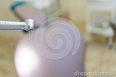 Dental handpiece with diamond bur close-up against the background of the dental chair Stock Photo