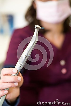 Dental handpiece with rubber cup for polishing teeth. Dental Instruments Stock Photo