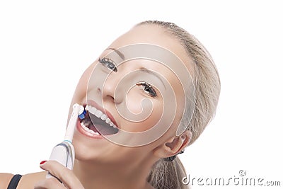 Dental Health: Blond Caucasian Woman Brushing Her Teeth with Electric Toothbrush Stock Photo