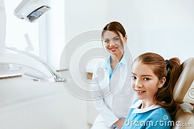Dental Health. Dentist And Happy Girl In Dentistry Office Stock Photo