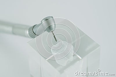 Dental high speed handpiece on a glass tooth Stock Photo