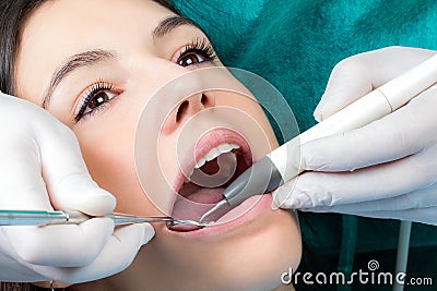 Dental hygienist cleaning girls teeth. Stock Photo