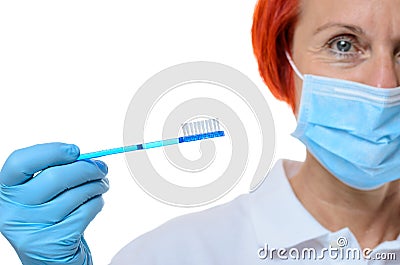 Dental hygienist in red hair with toothbrush Stock Photo