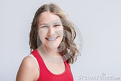 Dental and Medical Concept. Smiling Caucasian Young Blond Teenage Girl With Teeth Bracket System. Against White Background. Stock Photo