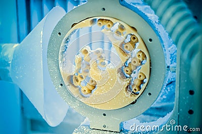 Dental milling machine carving out shape of human teeth Stock Photo