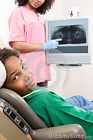 Dental nurse showing patient x ray Stock Photo