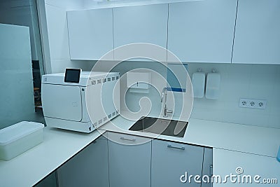 Dental office with cabinets, sink and instrument sterilization equipment Stock Photo