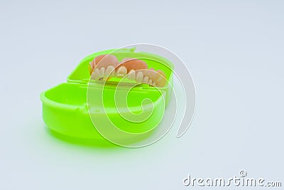 Dental prosthesis over a green box Stock Photo