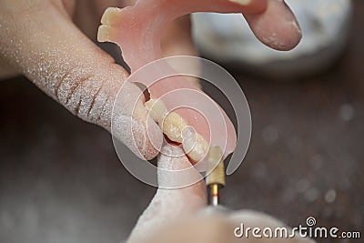 Dental technician make denture prothesis in dental laboratory Stock Photo