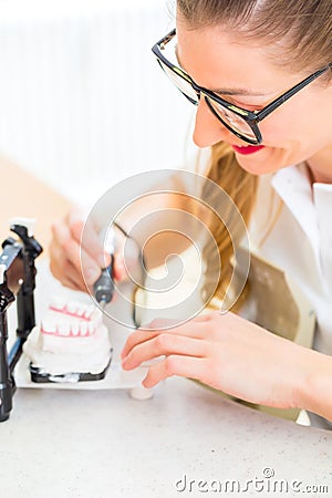 Dental technician producing denture Stock Photo