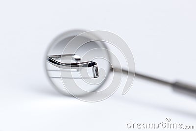 Dental tool reflected in the mirror on white background Stock Photo