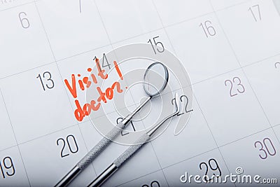 Dental tools on calendar with mark. Dental care concept Stock Photo